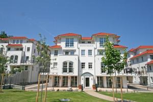 a large white building with red roof at Haus Meeresblick - 2.11 Sonnendeck in Baabe