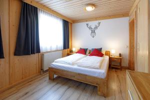 a bedroom with a bed and a large window at Landhaus Kitzblick in Piesendorf