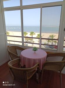 - une table dans une chambre avec vue sur la plage dans l'établissement PISO 1ª LINEA SANLUCAR DE BARRAMEDA, à Sanlúcar de Barrameda