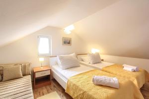 a bedroom with two beds and a window at Villa Gloria in Dubrovnik +58 photos