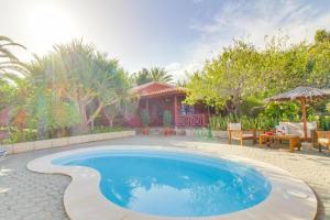 a swimming pool in front of a house at Villa Mimosa in Arafo