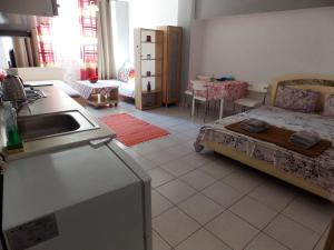 a kitchen with a sink and a bed in a room at Ladadika Studios in Thessaloniki