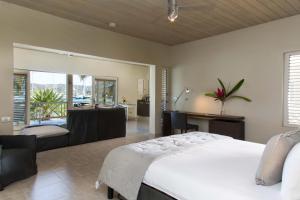 a bedroom with a large bed and a bathroom at South Point Antigua Ocean Suites in English Harbour Town +39 photos