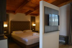 a bedroom with a bed with a wooden ceiling at Phaethon Apartments & Studios in Kallithea Halkidikis +86 photos
