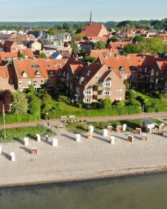 an aerial view of a town with houses and water at Ferienwohnung Strandhüpfer - direkt am Meer in Eckernförde