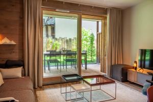 a living room with a couch and a table at Lapia 1 in Morzine