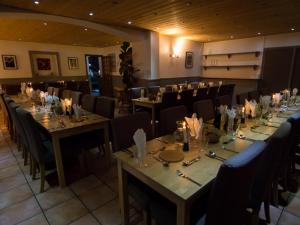 a dining room with long tables and chairs and sidx sidx sidx at Hotel Les Aravis in Saint-Jean-de-Sixt