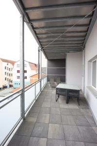 a balcony with a table and chairs on a building at Eat and Stay in Bad Salzungen
