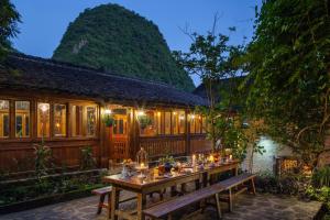 a long table in front of a building with lights at Yangshuo Secret Garden in Yangshuo