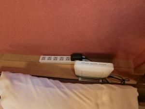 a bedroom with a bed with a heater and a phone at Shirahama Meiji Villa in Shirahama