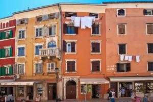 a building with clothes hanging on a clothes line at Ground Floor Gem (city centre) in Rovinj