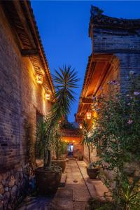 an alley with potted plants and a building at Yangshuo Secret Garden in Yangshuo