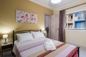 Postel nebo postele na pokoji v ubytování Gina’s House Argostoli