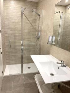 a bathroom with a shower and a white sink at Hotel BESTPRICE Alcalá in Madrid