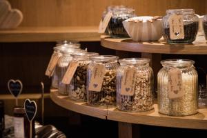 a display of jars of food on a shelf at Freina Mountain Lifestyle Hotel in Selva di Val Gardena