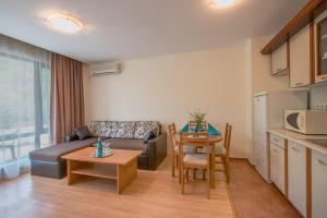 a living room with a couch and a table at Messambria Beach Apartments in Sveti Vlas