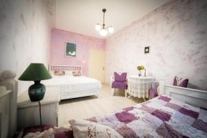 a bedroom with a bed and a table with chairs at Spalettás Porta - Vidéki Vendégház in Őrtilos +30 photos