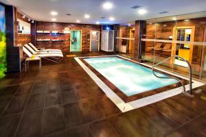 a large swimming pool in a room with at Parkhouse Hotel & Spa in Istanbul