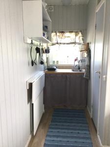 a small kitchen with a sink and a window at Stråvalla Hulegården in Stråvalla