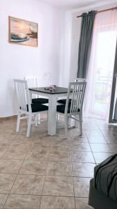 a dining room with a table and two chairs at Blue Sky Apartments in Slatine