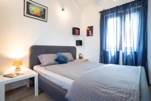 a bedroom with a bed and a table and a window at Apartment Juraj in Rovinj