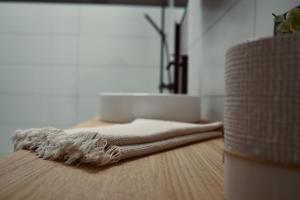 a pile of towels sitting on top of a wooden floor at La Terrasse - Résidence Le Cercle in Marche-en-Famenne +9 photos