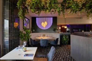 a restaurant with a table and chairs and a purple at Lochside House Hotel & Spa in New Cumnock