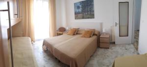 a bedroom with a large bed and a window at VRENI LODGE in Finale Ligure