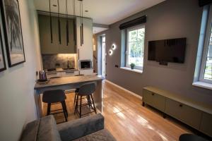 a kitchen with a table and chairs in a room at Apartment Austėja in Karklė