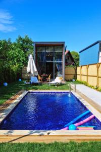 a swimming pool in a yard with a house at Minimalist Sapanca in Sapanca