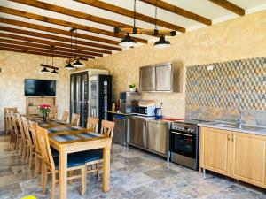 a large kitchen with a wooden table and chairs at Casa Eva in 2 Mai