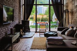 a living room with a couch and a brick wall at Minimalist Sapanca in Sapanca