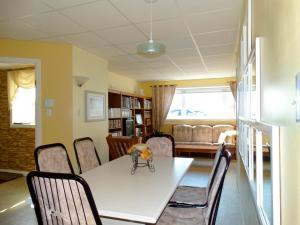 a dining room with a white table and chairs at Gite Parfum de Mer Bed and Breakfast in Pabos