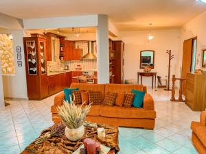 a living room with a couch and a kitchen at Dream Villa in Paleo Tsifliki