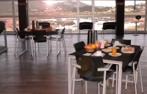 a restaurant with tables and chairs with food on them at Urdaibai Bird Center in Gautegiz Arteaga