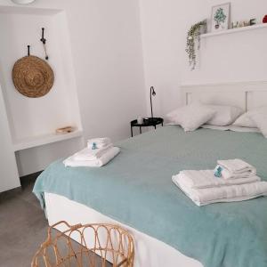 a bedroom with a bed with towels on it at Casetta Marconi....tra mare e storia! in Siculiana