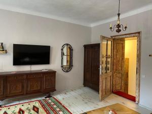 a living room with a flat screen tv and a door at Casa Poetului in Sibiu