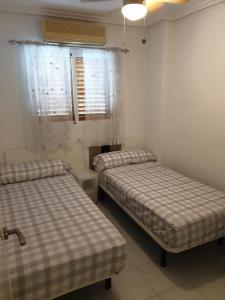 a room with two beds in a room at LUX Apartamento in La Mata