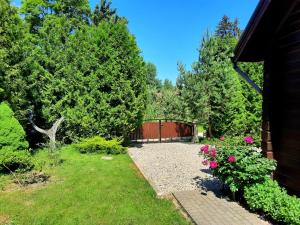 a garden with pink flowers and a fence at Sodyba Vilagio in Alanta +27 photos