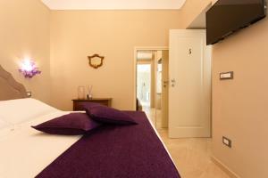 Postel nebo postele na pokoji v ubytování Maecò Ortigia B&B