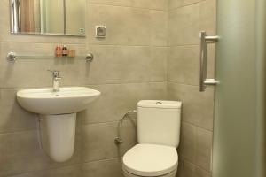 a bathroom with a toilet and a sink at Hostel Helios in Września +37 photos