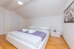 Posteľ alebo postele v izbe v ubytovaní Apartman Marla