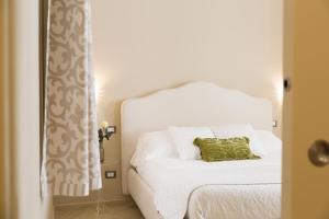 Postel nebo postele na pokoji v ubytování Maecò Ortigia B&B
