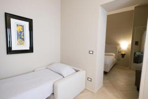 Postel nebo postele na pokoji v ubytování Maecò Ortigia B&B