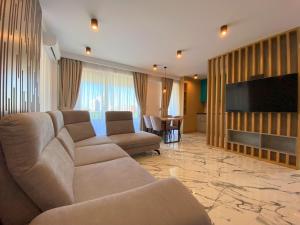 a living room with a couch and a flat screen tv at North Star Apartment 15 in Timişoara