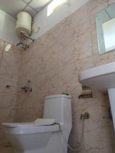 a bathroom with a toilet and a sink at The Green Pine Cottage in Lansdowne