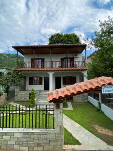 a house with a balcony and a fence at Casa Lanardi, Stavros in Stavros