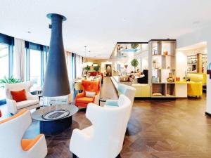 
a living room filled with furniture and appliances at Grand Hotel Bregenz - MGallery Hotel Collection in Bregenz
