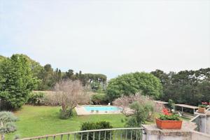 a view of a garden with a swimming pool at Relais Delle Rose in Lecce
