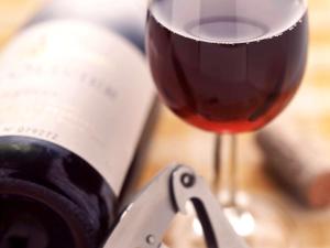 a glass of red wine next to a wine bottle at ibis Bordeaux Centre - Gare Saint-Jean in Bordeaux